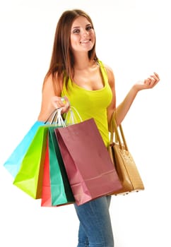Young happy woman with colorful paper shopping bags isolated on white
