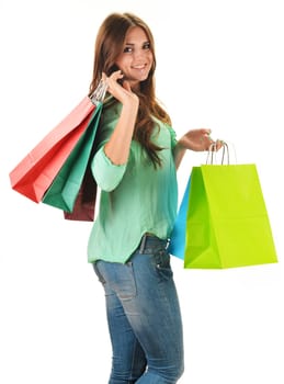 Young happy woman with colorful paper shopping bags isolated on white