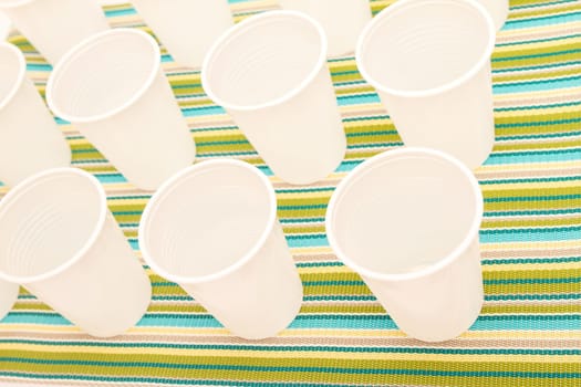 Lots of disposable cups on a colorful background.