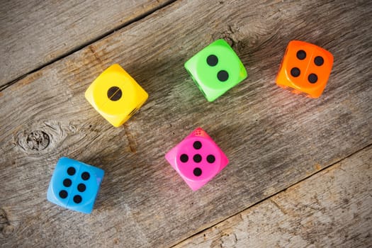 Colorful dice on the old wooden floor
