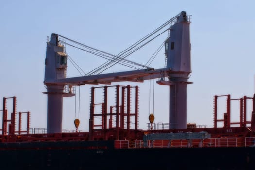 Ship cranes on a freighter in a close-up