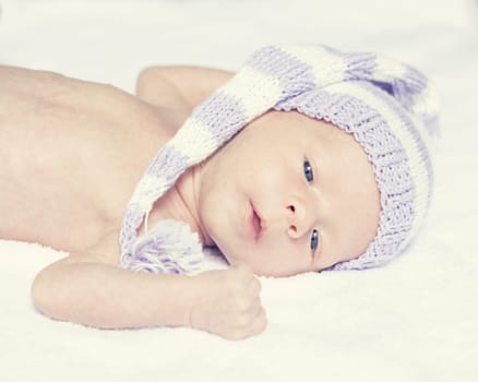 Cute beautiful baby is wearing a funny hat