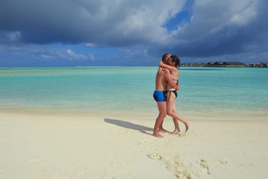 happy young  couple at summer vacation have fun and relax at beautiful sunny  day on beach