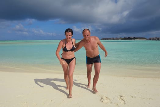 happy young  couple at summer vacation have fun and relax at beautiful sunny  day on beach