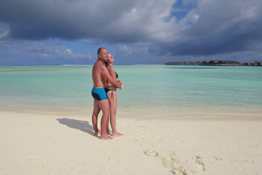 happy young  couple at summer vacation have fun and relax at beautiful sunny  day on beach