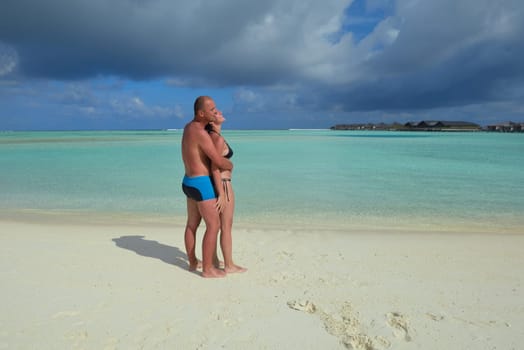 happy young  couple at summer vacation have fun and relax at beautiful sunny  day on beach