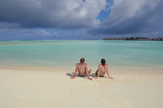 happy young  couple at summer vacation have fun and relax at beautiful sunny  day on beach