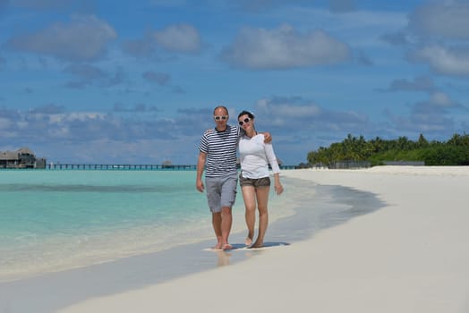 happy young  couple at summer vacation have fun and relax at beautiful sunny  day on beach