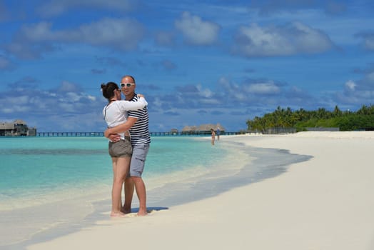 happy young  couple at summer vacation have fun and relax at beautiful sunny  day on beach