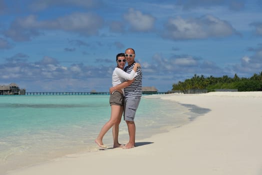 happy young  couple at summer vacation have fun and relax at beautiful sunny  day on beach