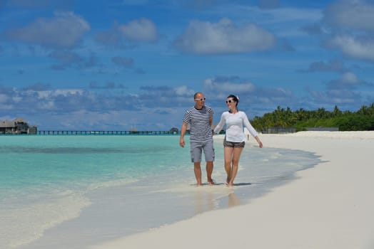 happy young  couple at summer vacation have fun and relax at beautiful sunny  day on beach