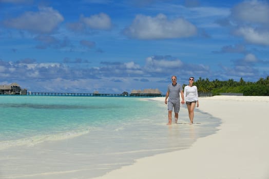 happy young  couple at summer vacation have fun and relax at beautiful sunny  day on beach