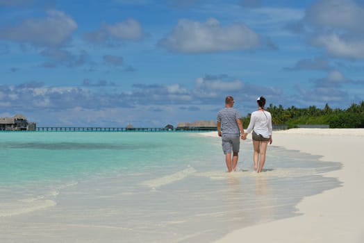 happy young  couple at summer vacation have fun and relax at beautiful sunny  day on beach
