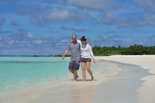 happy young  couple at summer vacation have fun and relax at beautiful sunny  day on beach