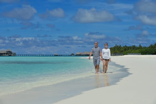 happy young  couple at summer vacation have fun and relax at beautiful sunny  day on beach