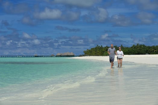 happy young  couple at summer vacation have fun and relax at beautiful sunny  day on beach