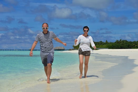 happy young  couple at summer vacation have fun and relax at beautiful sunny  day on beach