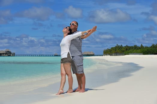 happy young  couple at summer vacation have fun and relax at beautiful sunny  day on beach
