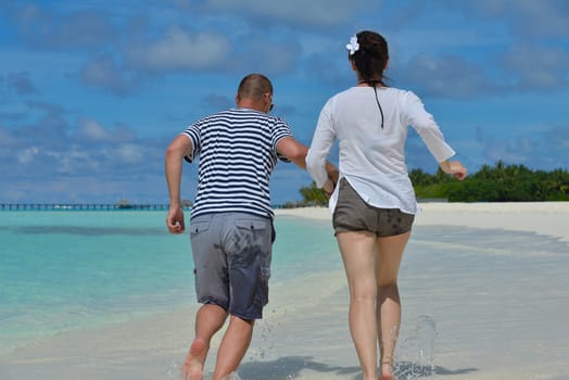 happy young  couple at summer vacation have fun and relax at beautiful sunny  day on beach
