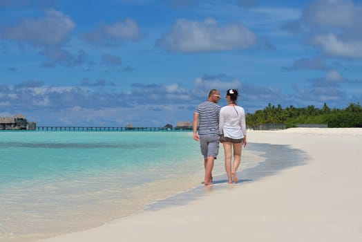 happy young  couple at summer vacation have fun and relax at beautiful sunny  day on beach