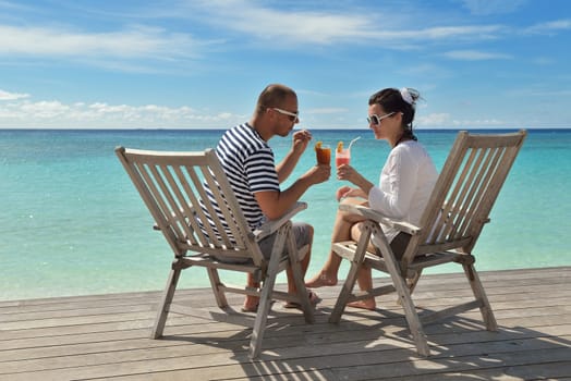 happy young couple relax and take fresh drink at summer vacation