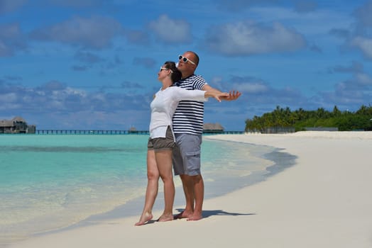 happy young  couple at summer vacation have fun and relax at beautiful sunny  day on beach