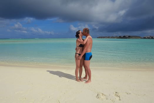 happy young  couple at summer vacation have fun and relax at beautiful sunny  day on beach