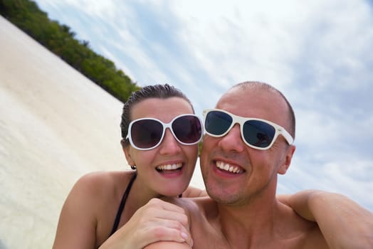 happy young  couple at summer vacation have fun and relax at beautiful sunny  day on beach
