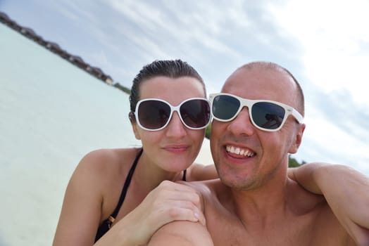 happy young  couple at summer vacation have fun and relax at beautiful sunny  day on beach