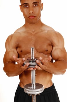 A picture from the front of a young bodybuilder in black shorts lifting.two silver colour dumbbells in his exercises..