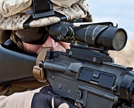 Close-up shot of US marine shooting his rifle
