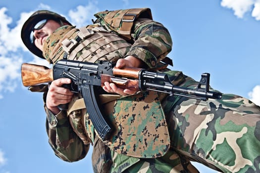 soldier in bulletproof vest with ak-47 rifle