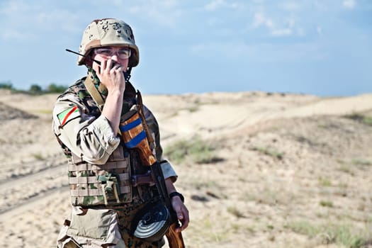 iraqi soldier in the desert talking portable radio station