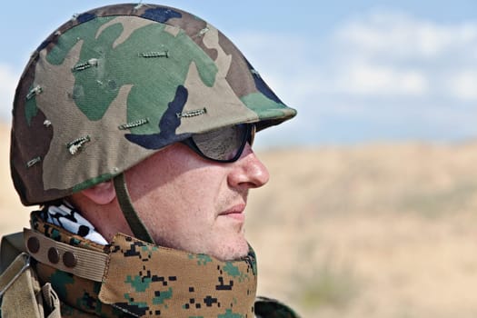 soldier in the military helmet half-turned to the camera