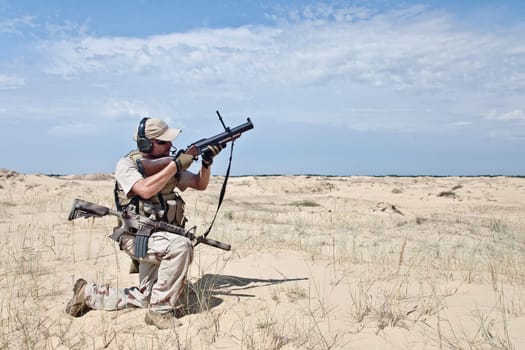 US marine aiming a gun with grenade launcher