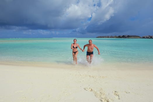happy young  couple at summer vacation have fun and relax at beautiful sunny  day on beach