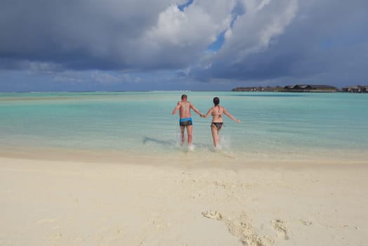 happy young  couple at summer vacation have fun and relax at beautiful sunny  day on beach