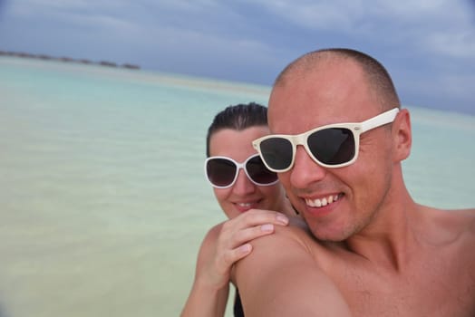 happy young  couple at summer vacation have fun and relax at beautiful sunny  day on beach