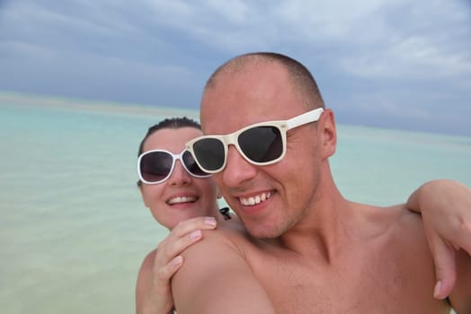 happy young  couple at summer vacation have fun and relax at beautiful sunny  day on beach