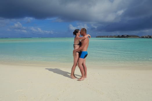 happy young  couple at summer vacation have fun and relax at beautiful sunny  day on beach