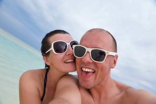 happy young  couple at summer vacation have fun and relax at beautiful sunny  day on beach