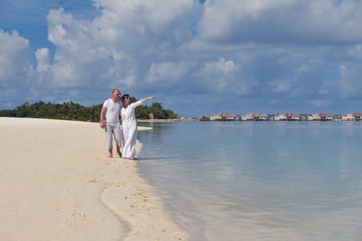 happy young  couple at summer vacation have fun and relax at beautiful sunny  day on beach