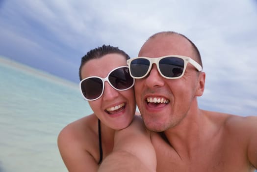 happy young  couple at summer vacation have fun and relax at beautiful sunny  day on beach