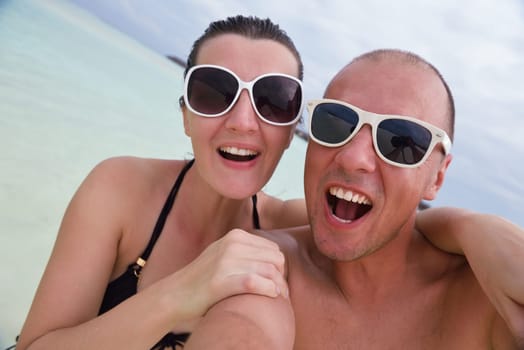 happy young  couple at summer vacation have fun and relax at beautiful sunny  day on beach