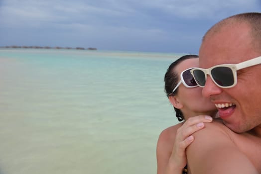 happy young  couple at summer vacation have fun and relax at beautiful sunny  day on beach