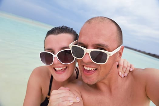 happy young  couple at summer vacation have fun and relax at beautiful sunny  day on beach