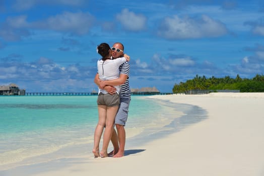 happy young  couple at summer vacation have fun and relax at beautiful sunny  day on beach