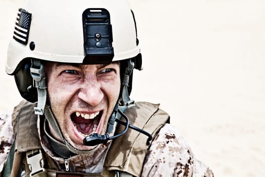 Scary face of US marine in the marpat uniform showing teeth