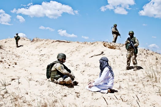 Squad of soldiers guarding the perimeter while negotiations with muslim warrior are going on