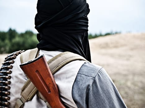Muslim rebel with automatic rifle and machine-gun belt